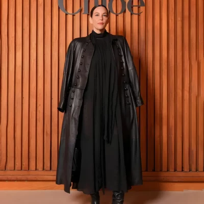 Liv Tyler Paris Fashion Week black leather coat with button front closure and shirt collar elegant long coat style